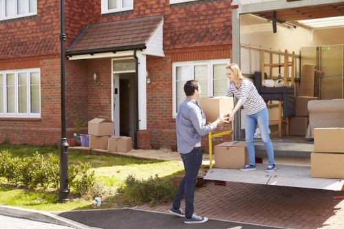 Trained moving staff handling items safely with protective gear
