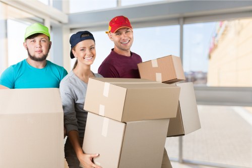 Professional moving team loading boxes into a removal van