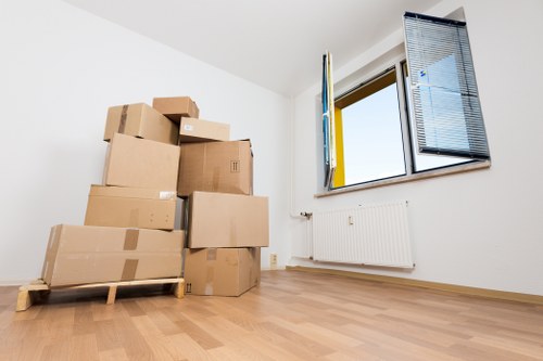 Workers carefully handling desks and equipment during an office move