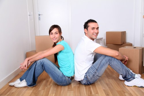 Staff using proper manual handling techniques with furniture